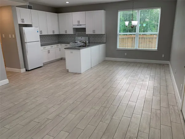 a kitchen with cabinets and window