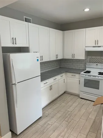 a white refrigerator freezer sitting inside of a kitchen
