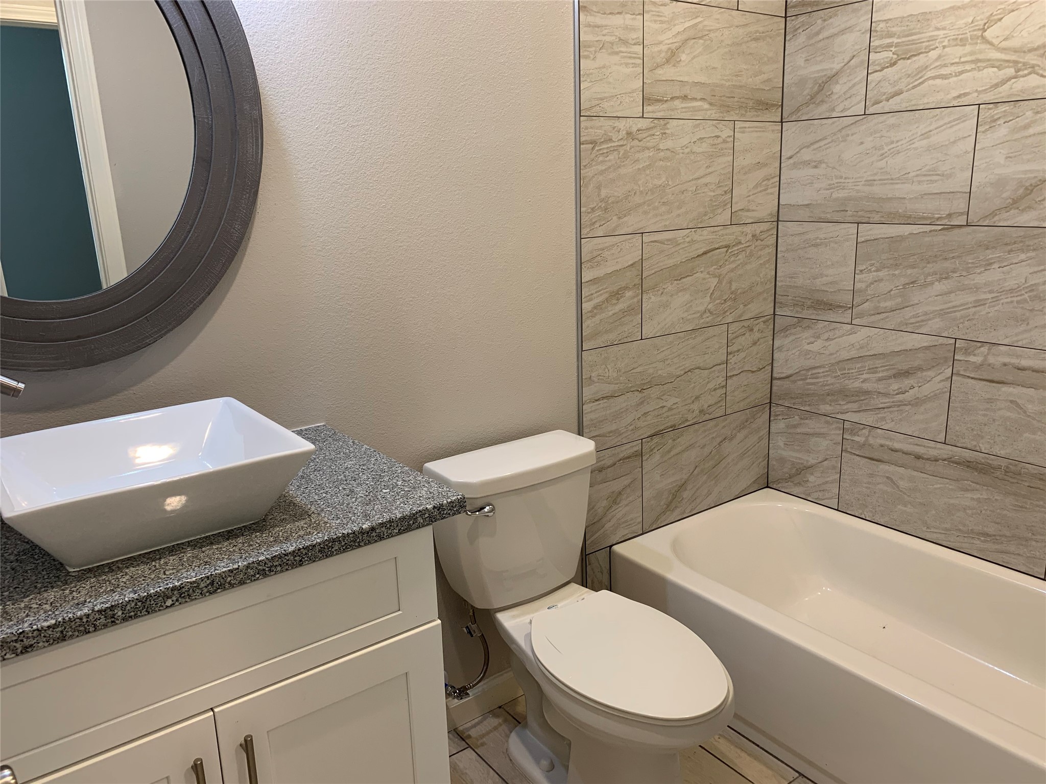 4221 Alvin Street, Unit A Houston, TX 77051 - Photo 8 of 15 a bathroom with a granite countertop toilet and a sink