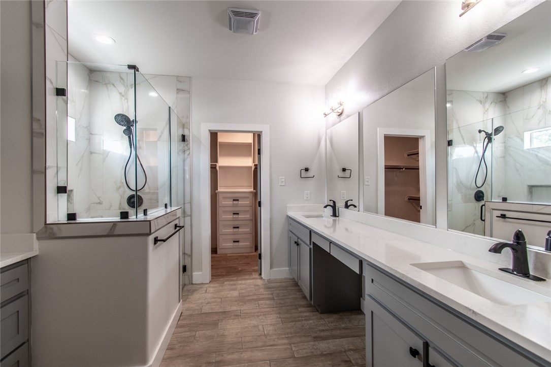 4801 Del Paseo Street Corpus Christi, TX 78411 - Photo 11 of 36 a spacious bathroom with a double vanity sink a mirror and shower