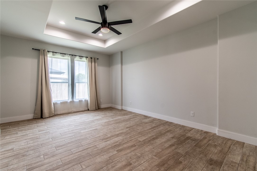 4801 Del Paseo Street Corpus Christi, TX 78411 - Photo 16 of 36 a view of empty room with wooden floor and fan