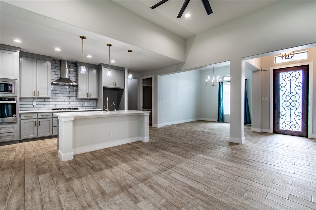4801 Del Paseo Street Corpus Christi, TX 78411 - Photo 20 of 36 a large kitchen with stainless steel appliances granite countertop a large counter top a sink and a refrigerator