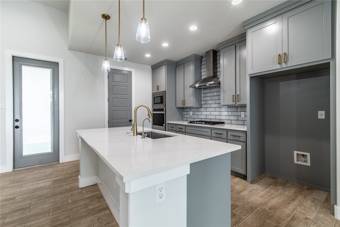 4801 Del Paseo Street Corpus Christi, TX 78411 - Photo 28 of 36 a kitchen with kitchen island a sink appliances and cabinets