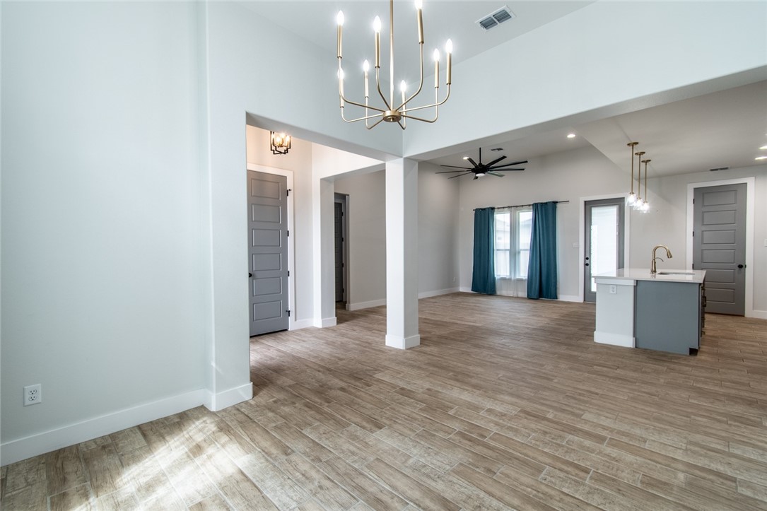 4801 Del Paseo Street Corpus Christi, TX 78411 - Photo 30 of 36 a view of a hallway with wooden floor and a kitchen