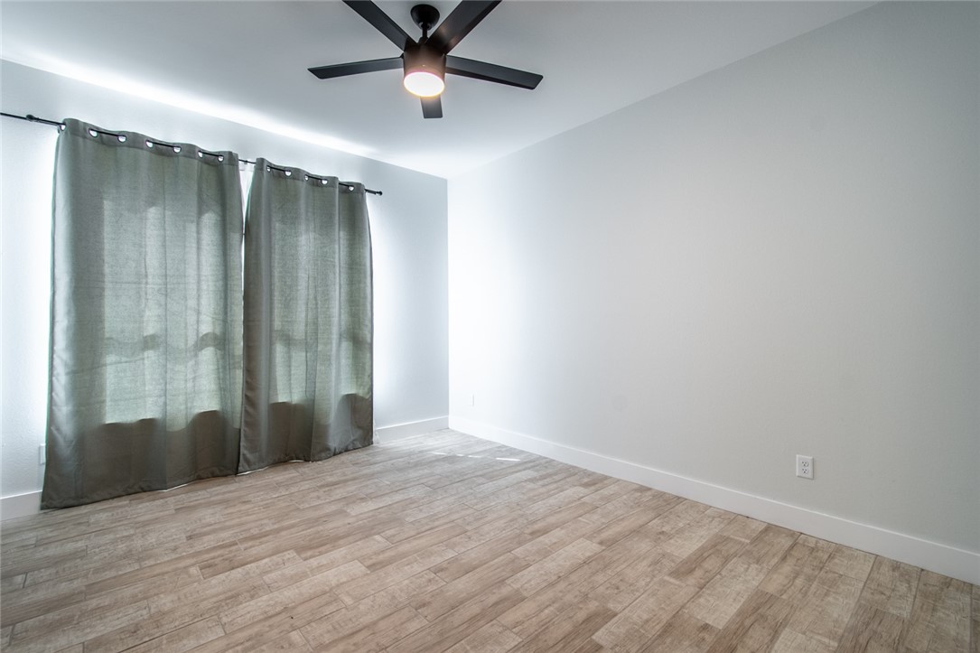4801 Del Paseo Street Corpus Christi, TX 78411 - Photo 31 of 36 an empty room with wooden floor and windows