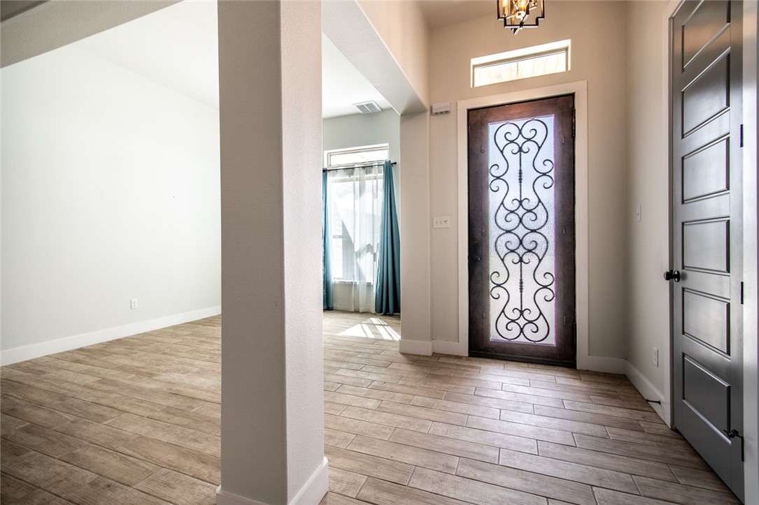 4801 Del Paseo Street Corpus Christi, TX 78411 - Photo 36 of 36 an empty room with wooden floor and windows
