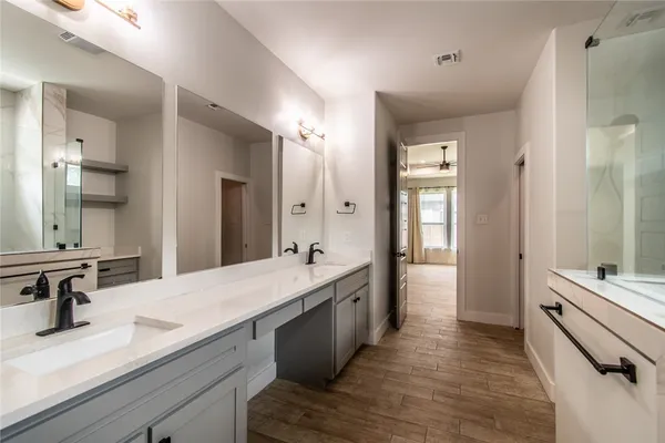 a bathroom with a double vanity sink a mirror and a shower