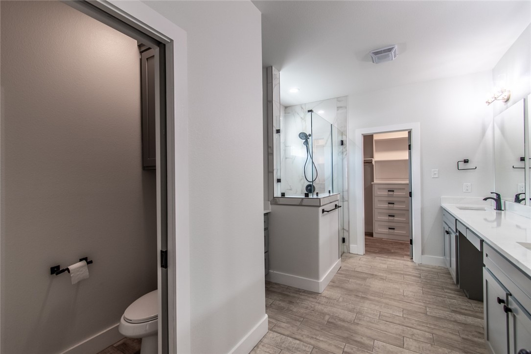 4801 Del Paseo Street Corpus Christi, TX 78411 - Photo 10 of 36 a bathroom with a granite countertop sink toilet and shower