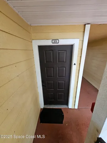 a view of front door with wooden floor