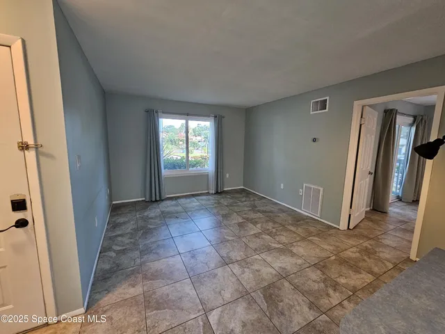 a bathroom with a granite countertop toilet sink and mirror