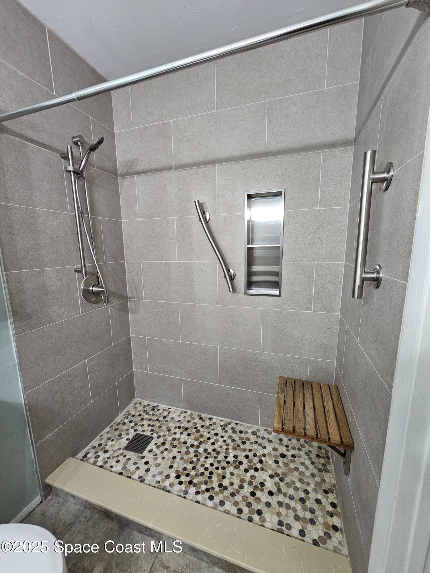 225 South Tropical Trail, Unit 201 Merritt Island, FL 32952 - Photo 8 of 14 a bathroom with a shower