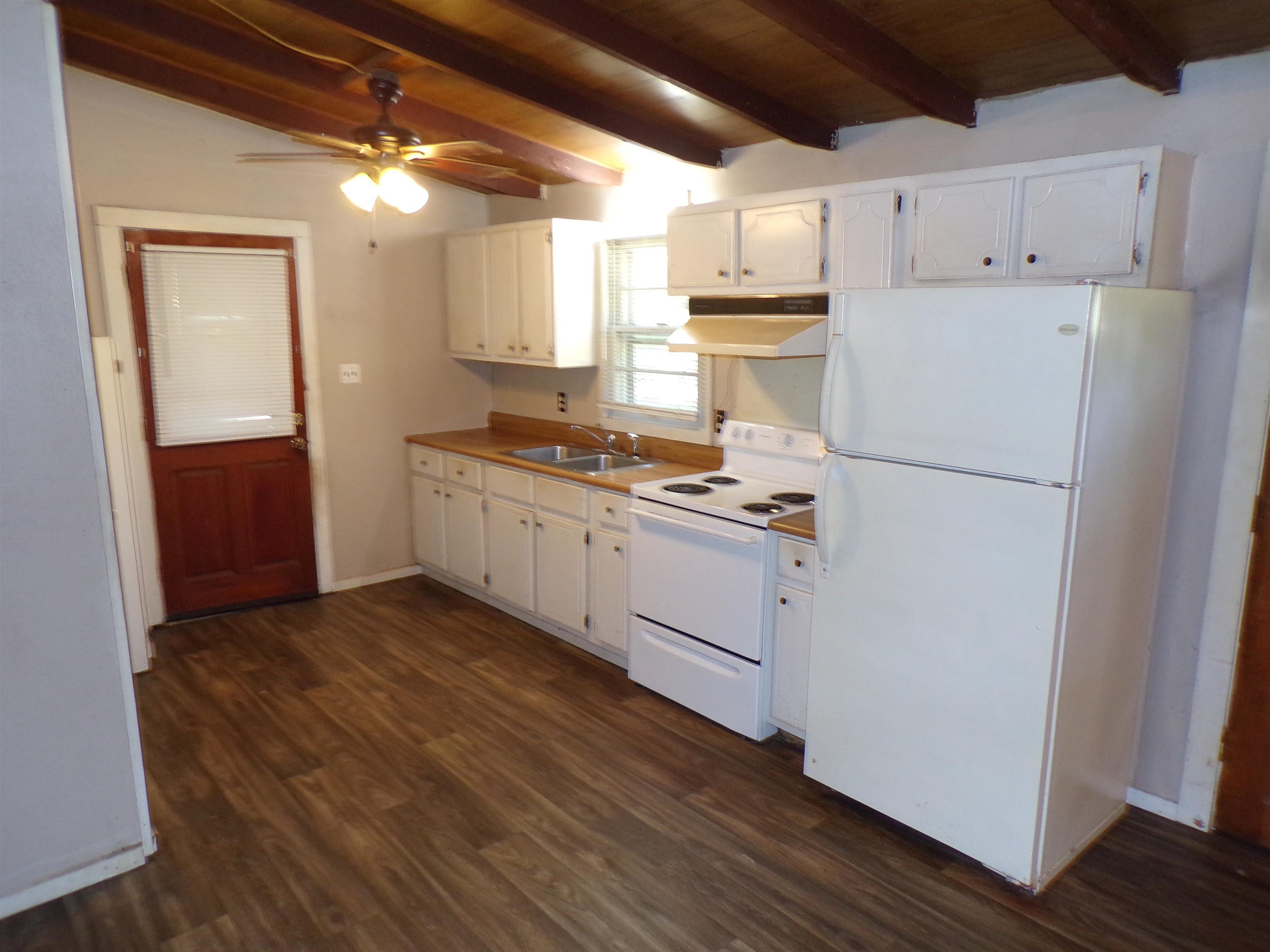 35 Cr 341 Road Iuka, MS 38852 - Photo 5 of 15 Kitchen featuring wood-finish flooring, white cabinetry, light wood-finish countertops, and a white appliance suite
