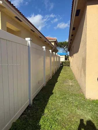 a view of an house with backyard space and sitting area