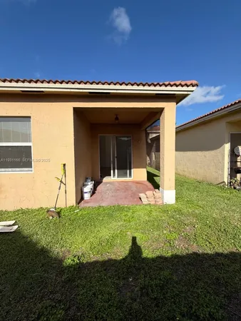 a view of backyard with barbeque grill and stairs