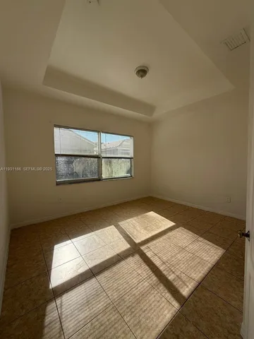 a kitchen with a refrigerator sink and cabinets