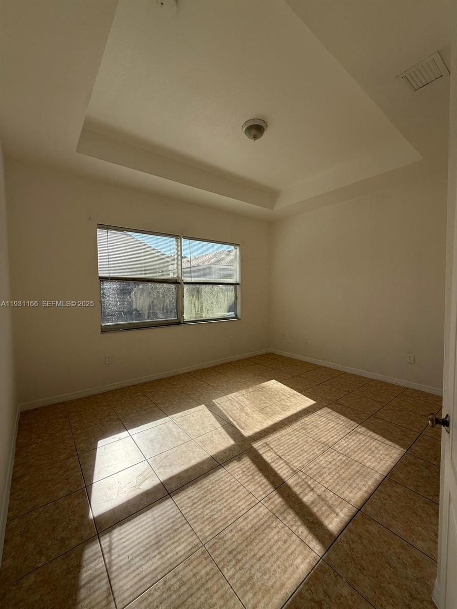 2221 Northeast 37th Terrace Homestead, FL 33033 - Photo 7 of 24 an empty room with wooden floor and windows