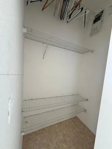 a small space with a fan and a window