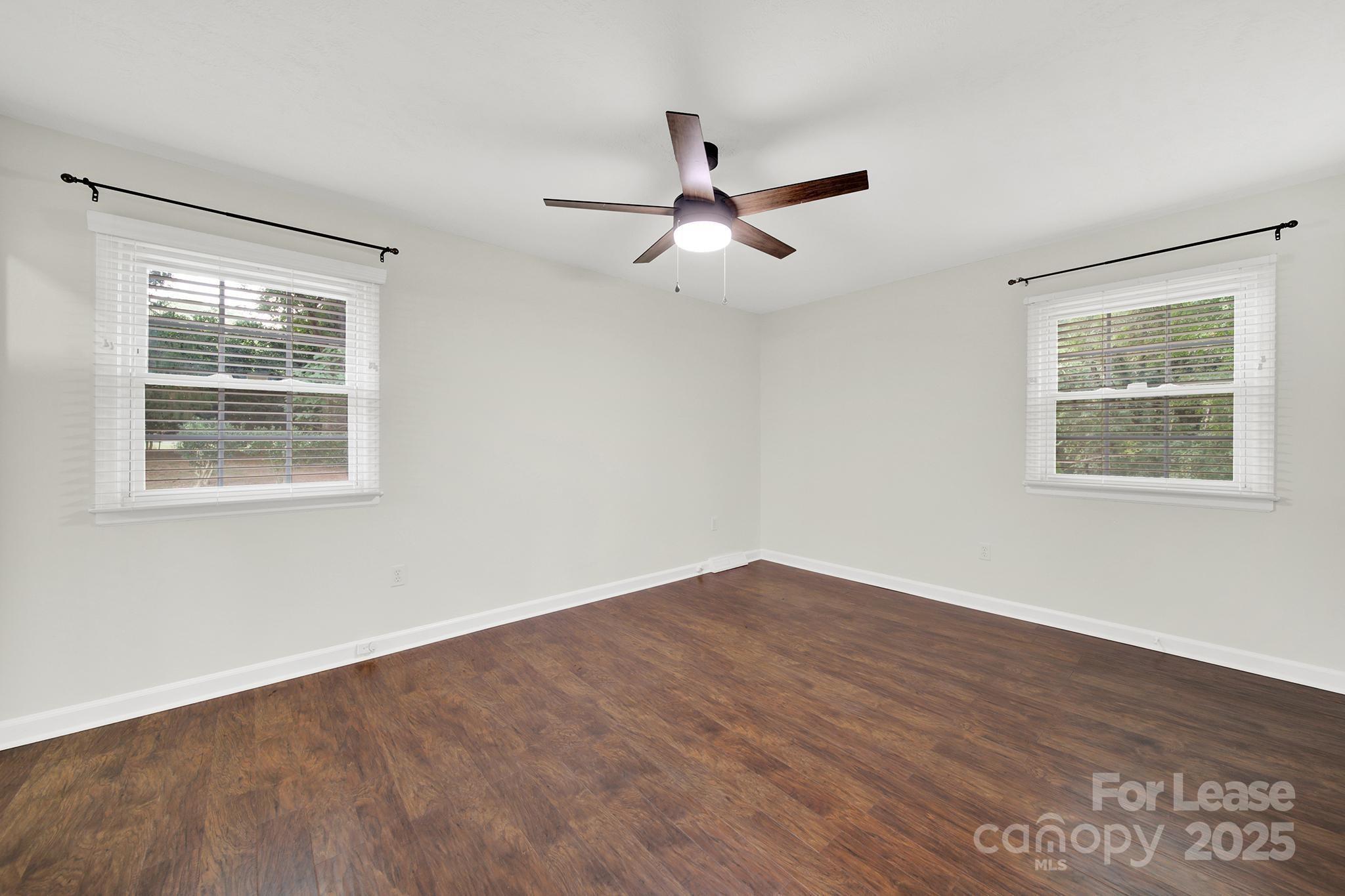 2400 Fox Hollow Road Mint Hill, NC 28227 - Photo 21 of 32 a view of empty room with wooden floor and fan