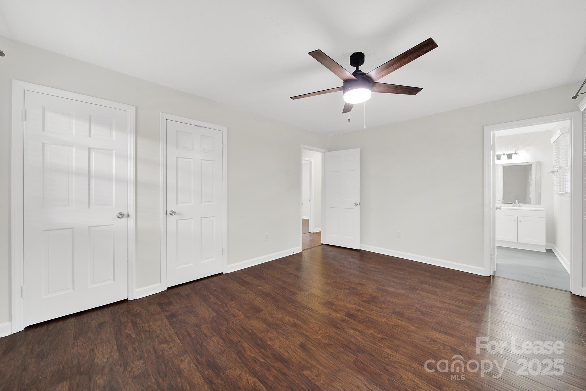 2400 Fox Hollow Road Mint Hill, NC 28227 - Photo 22 of 32 a view of an empty room with wooden floor