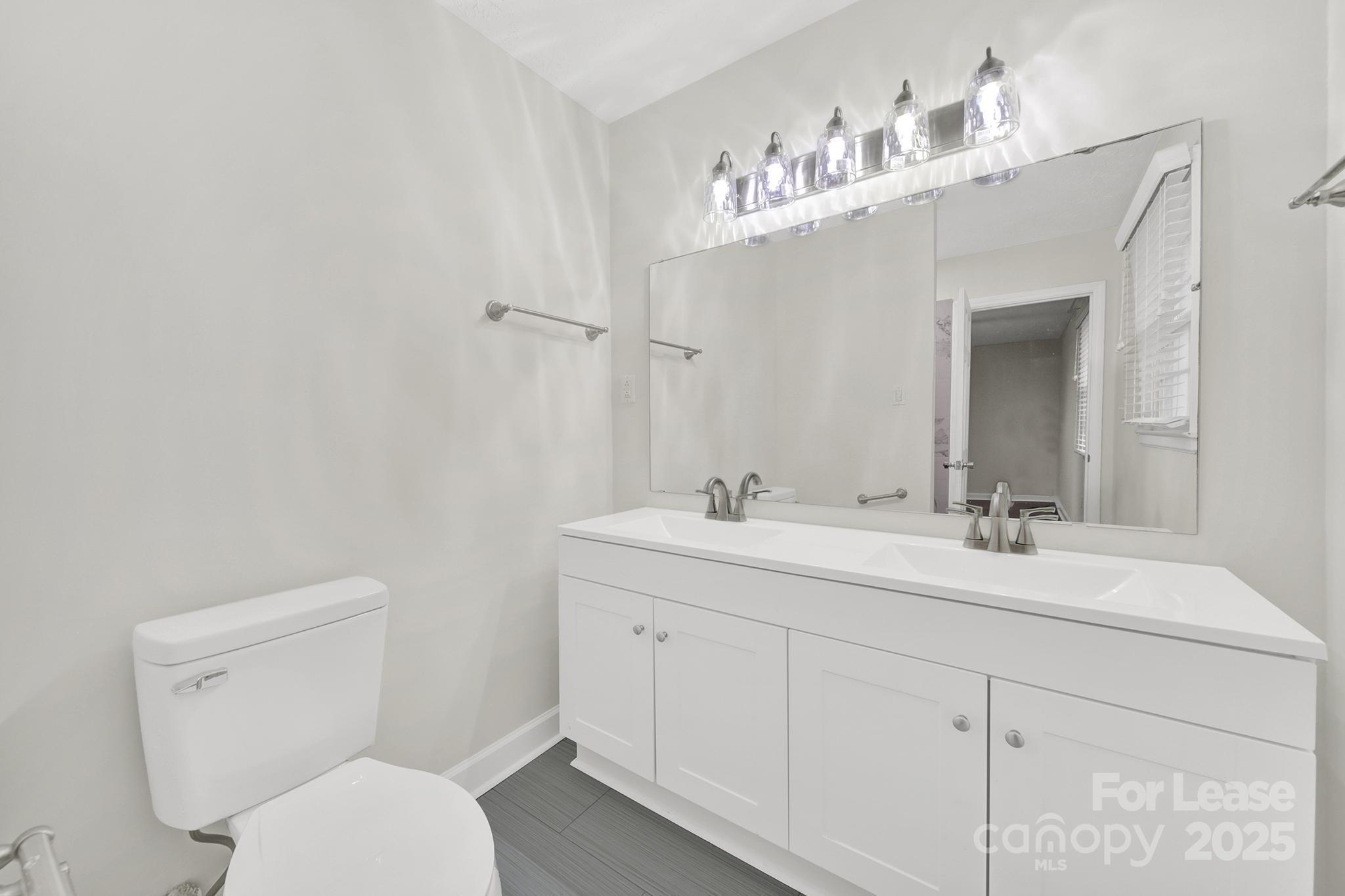 2400 Fox Hollow Road Mint Hill, NC 28227 - Photo 23 of 32 a bathroom with a toilet sink and mirror