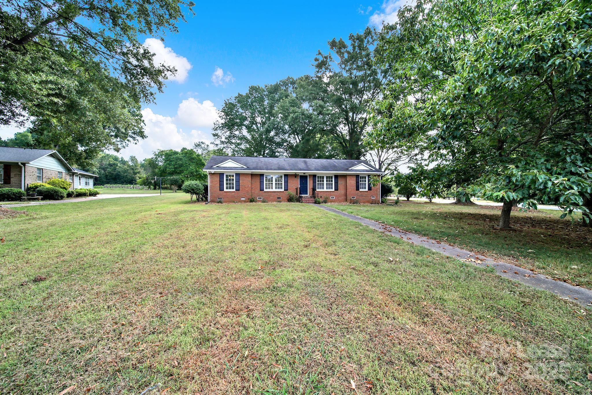 2400 Fox Hollow Road Mint Hill, NC 28227 - Photo 29 of 32 a view of a house with garden and trees