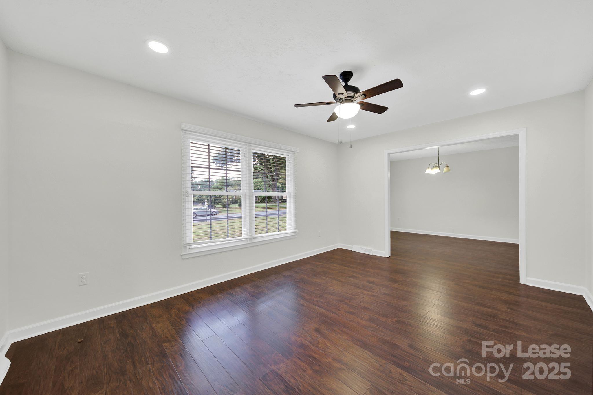 2400 Fox Hollow Road Mint Hill, NC 28227 - Photo 3 of 32 a view of empty room with wooden floor and fan
