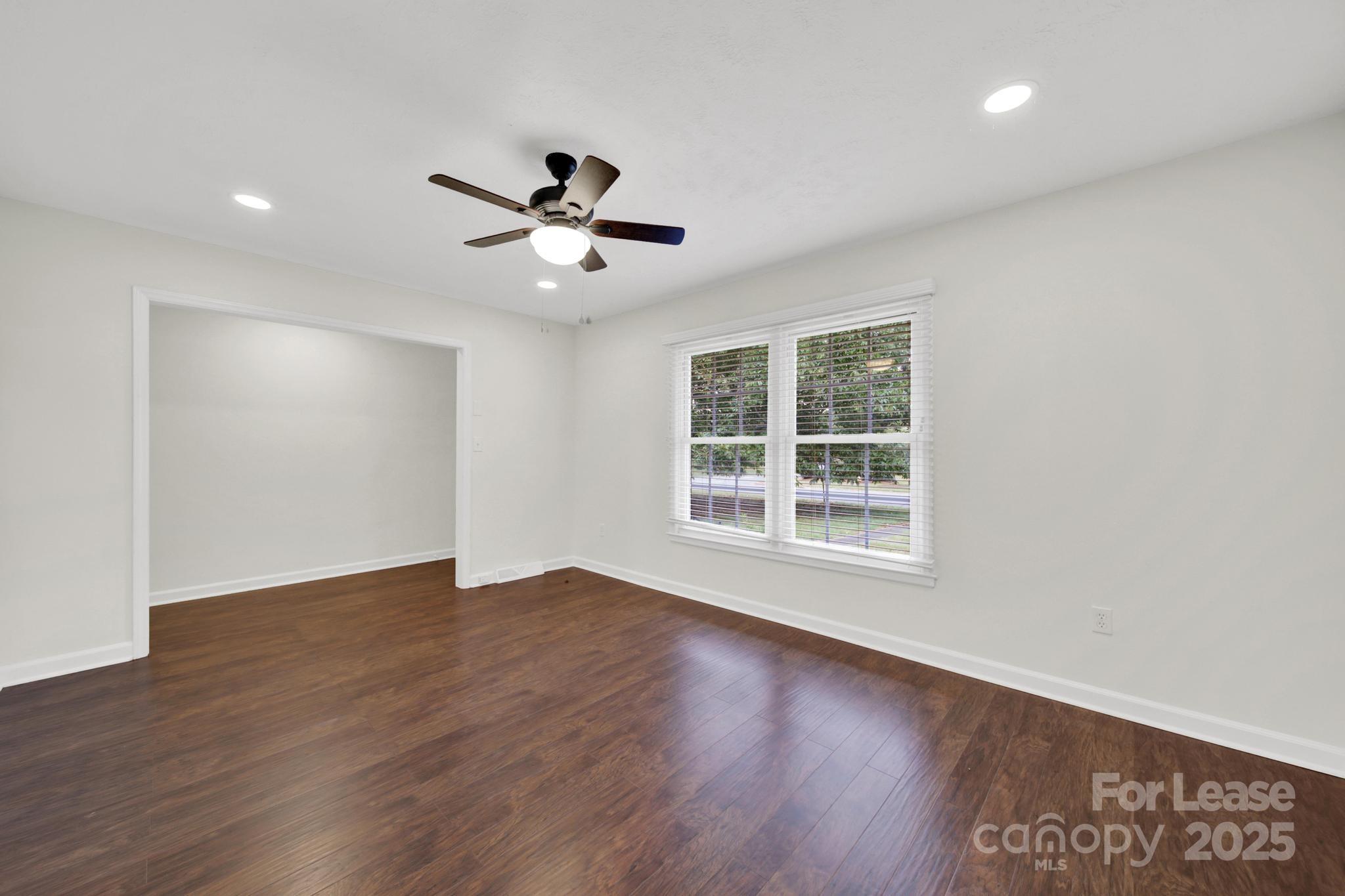 2400 Fox Hollow Road Mint Hill, NC 28227 - Photo 4 of 32 a view of empty room with wooden floor and fan