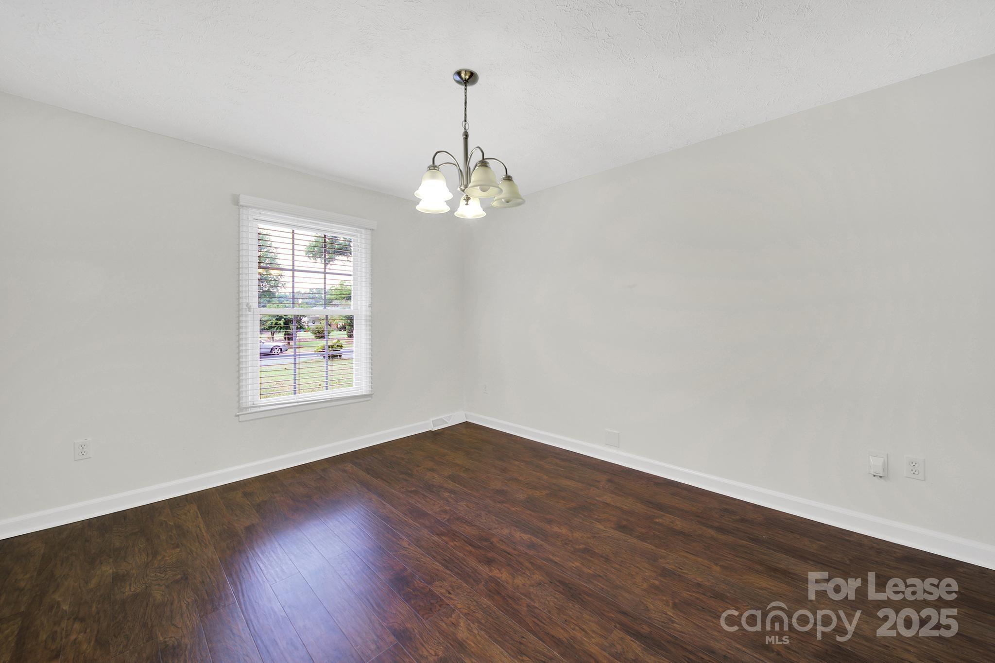 2400 Fox Hollow Road Mint Hill, NC 28227 - Photo 5 of 32 wooden floor in an empty room with a window