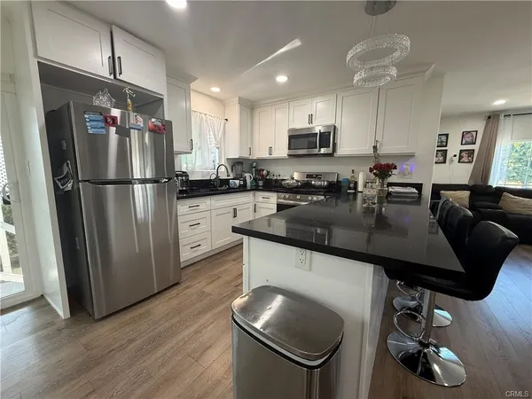 a kitchen with counter top space cabinets and appliances