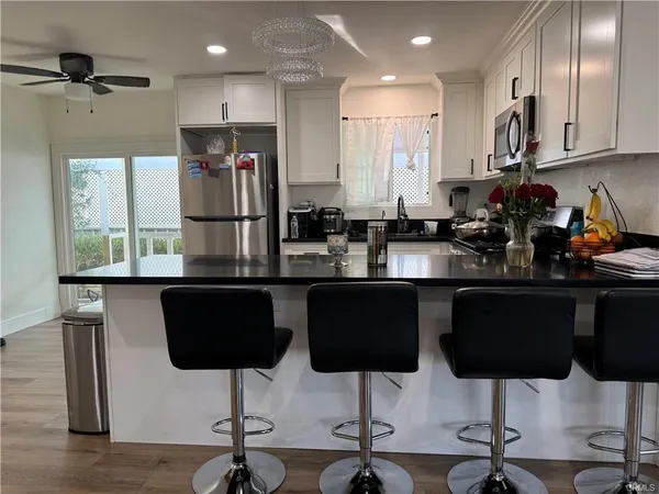 a kitchen with stainless steel appliances granite countertop a sink stove and cabinets