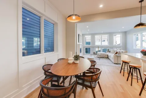 a kitchen with a dining table and chairs