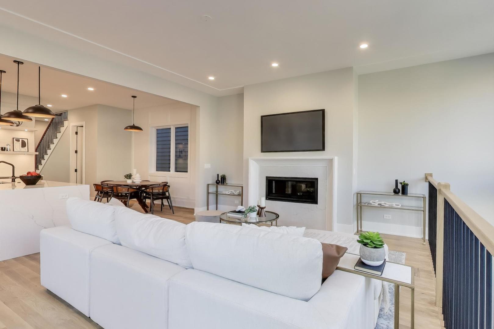 3929 North Francisco Avenue Chicago, IL 60618 - Photo 15 of 47 a living room with furniture a fireplace and a flat screen tv