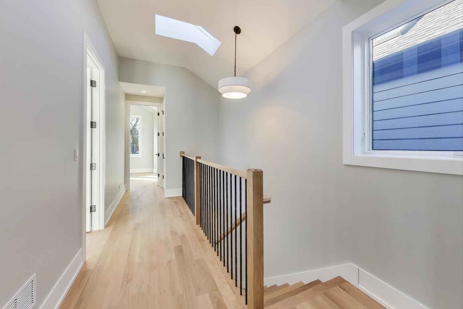3929 North Francisco Avenue Chicago, IL 60618 - Photo 20 of 47 a view of a hallway with wooden floor and staircase