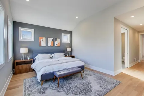 a bedroom with a bed and a couch