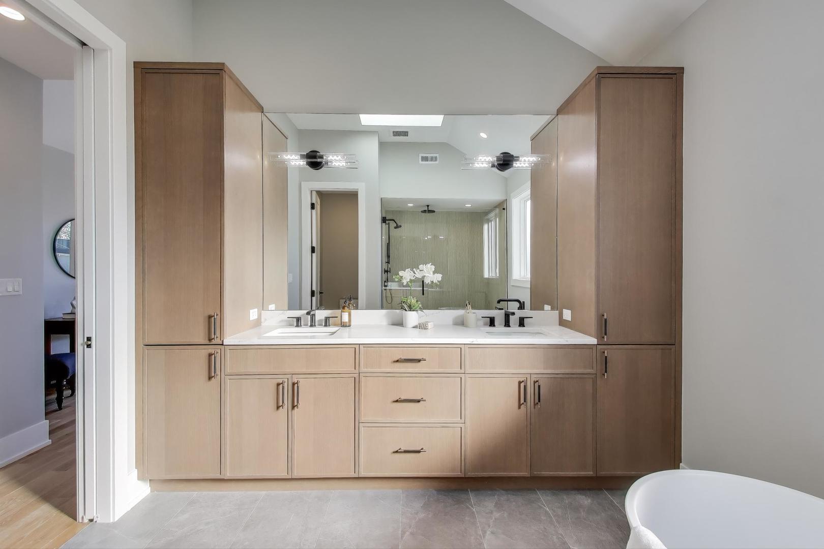 3929 North Francisco Avenue Chicago, IL 60618 - Photo 25 of 47 a bathroom with a sink a toilet a large mirror and vanity
