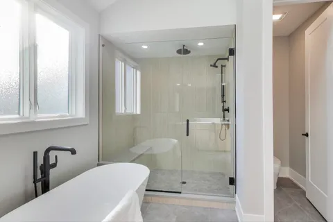 a bathroom with a shower a toilet and sink