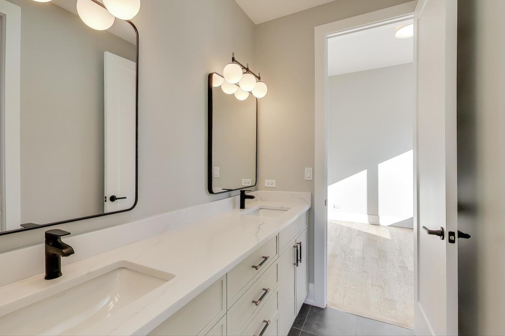 3929 North Francisco Avenue Chicago, IL 60618 - Photo 29 of 47 a bathroom with a sink and a mirror