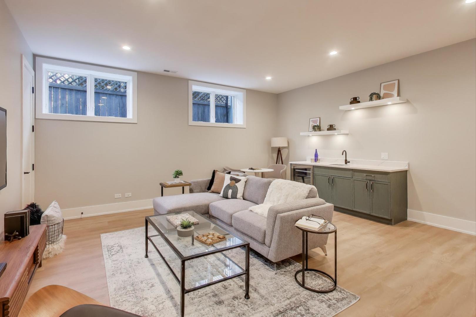 3929 North Francisco Avenue Chicago, IL 60618 - Photo 34 of 47 a living room with furniture a rug and kitchen view