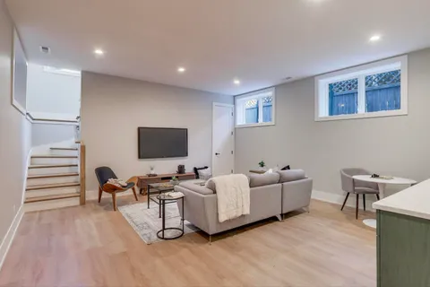 a living room with furniture and a wooden floor