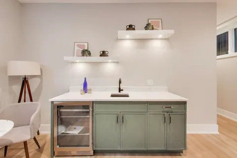 a kitchen with a sink cabinets and wooden floor