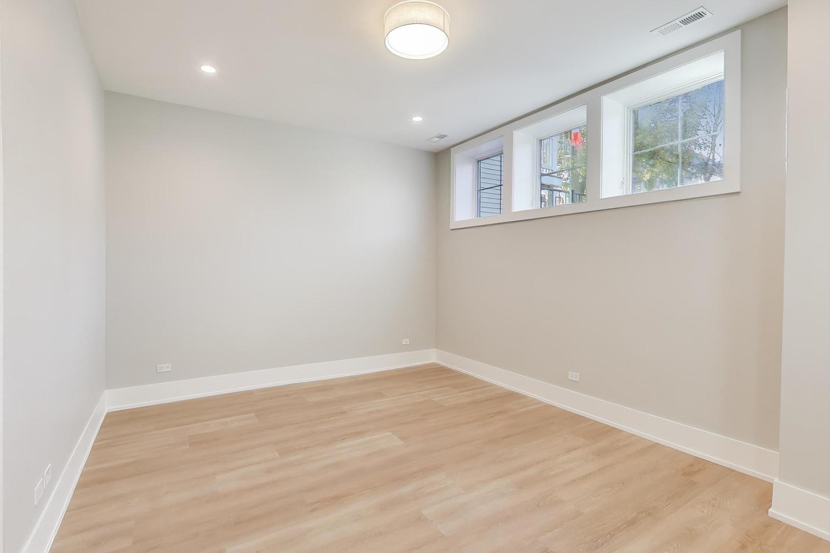 3929 North Francisco Avenue Chicago, IL 60618 - Photo 38 of 47 an empty room with windows and refrigerator