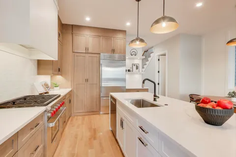 a kitchen that has a lot of cabinets and appliances