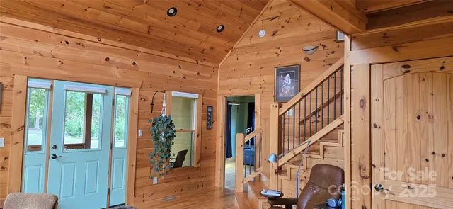 a view of entryway with wooden floor and stairs