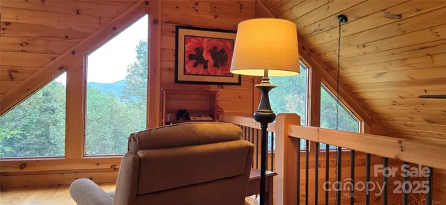 a backyard of a house with wooden floor and outdoor seating