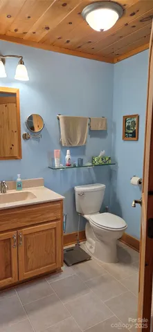 a bathroom with a toilet a sink and a mirror