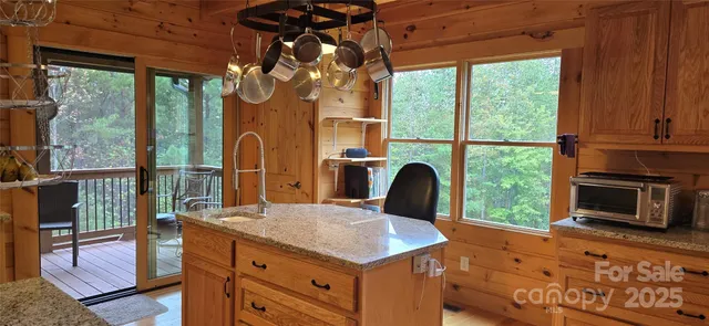 a kitchen with a stove a sink a dining table and chairs