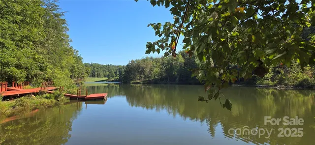 a lake view with a wooden bridge