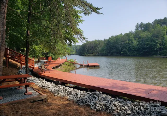 a view of a lake with chairs