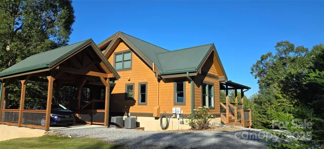 a view of house and outdoor space with swimming pool and sitting space