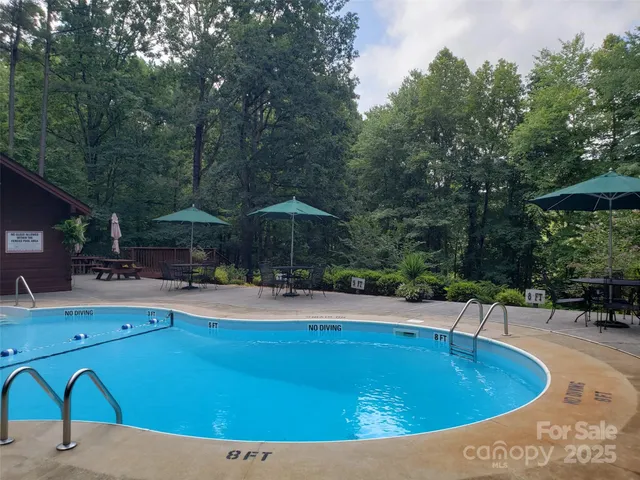 a swimming pool with outdoor seating and yard